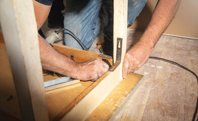 Caucasian carpenter repairing broken table.
