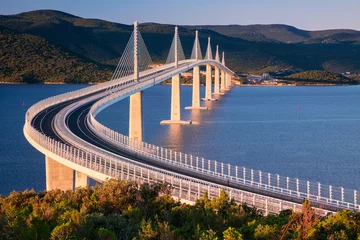 Fototapeten Peljesac Bridge, Croatia. Image of beautiful modern multi-span cable-stayed Peljesac Bridge over the sea in Dubrovnik-Neretva County, Croatia at sunrise. © rudi1976
