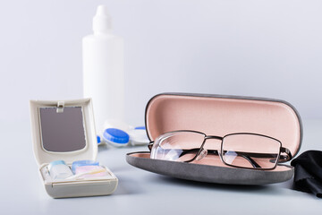 Box for storing contact lens care items and glasses in a case. Choosing a vision correction method