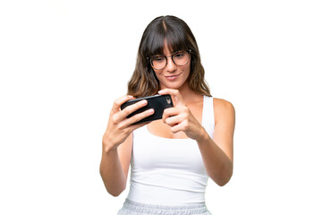 Young caucasian woman over isolated background playing with the mobile phone © luismolinero