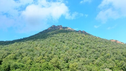 Forest green mountain and blue sky and rock,  shot on 5 December 2021, Karnataka, India.