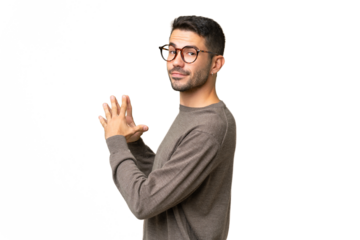 Young handsome caucasian man over isolated background scheming something