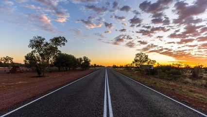 Fotobehang Chocoladebruin Straight line on an Australian highway through the outback at dusk   © serge