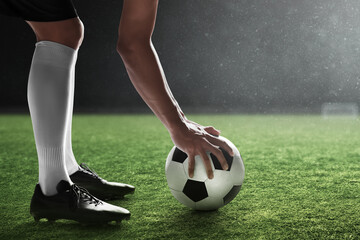Fototapeta na wymiar Soccer player holding ball in the stadium