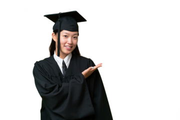 Young university graduate Asian woman over isolated background presenting an idea while looking smiling towards