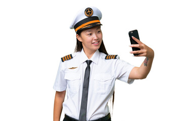 Airplane pilot Asian woman over isolated background making a selfie