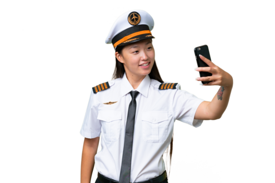 Airplane pilot Asian woman over isolated background making a selfie