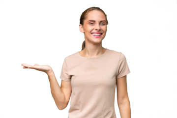 Young caucasian woman over isolated background holding copyspace imaginary on the palm to insert an ad