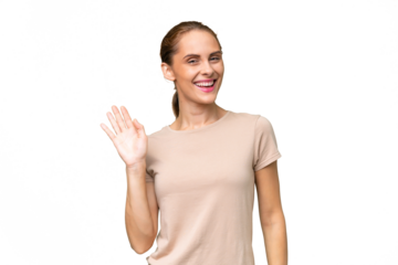 Young caucasian woman over isolated background saluting with hand with happy expression