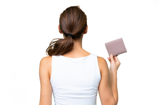 Young caucasian woman holding a wallet over isolated background in back position