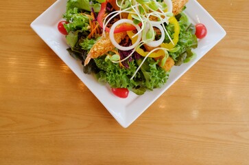 Fresh salad with salmon, avocado, and tomatoes on a plate
