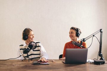 Female content creators recording a podcast in a home studio - obrazy, fototapety, plakaty