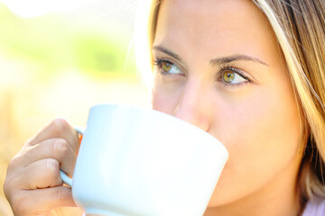 Woman with beauty eyes drinking coffee