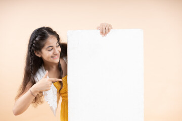 Young girl  holding a blank board with thumbs up