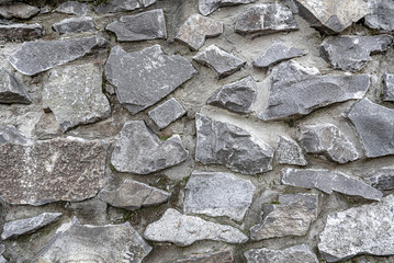 Stone masonry of large cobblestones. The texture is clearly visible.