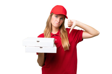 Young caucasian pizza delivery woman with work uniform picking up pizza boxes over isolated...