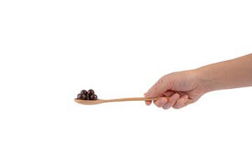 Fototapeta na wymiar Hand and chocolate balls on wooden spoon on transparent background.