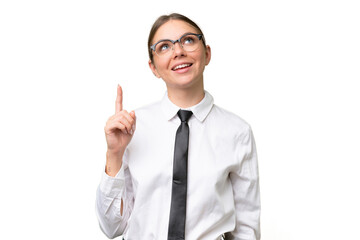 Young business caucasian woman over isolated background pointing up and surprised