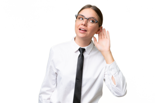 Young business caucasian woman over isolated background listening to something by putting hand on the ear