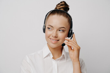 Friendly woman in headset speaking with customer