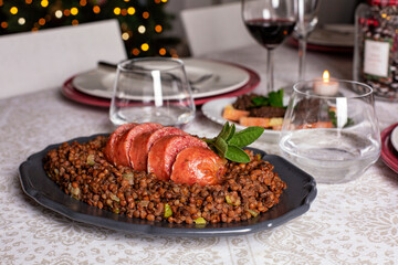 An Italian New Year Eve table. Traditional cotechino con lenticchie or pork sausage with Lentils...