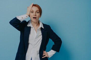 Shocked stressed businesswoman in formal wear hearing bad unexpected news, holding hand on head