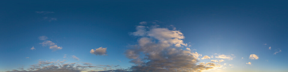 Panorama of a dark blue sunset sky with golden Cumulus clouds. Seamless hdr 360 panorama in spherical equiangular format. Full zenith for 3D visualization, sky replacement for aerial drone panoramas.