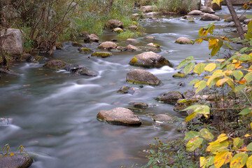 Naklejka na ściany i meble Photography of a stream flowing slowly in the mountain area of Beijing in autumn