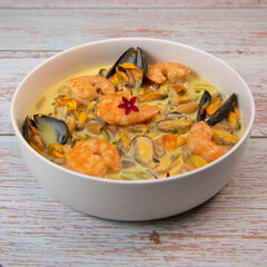 Recipe for marinated mussels with fresh cream, saffron curry and prawns. High quality photo