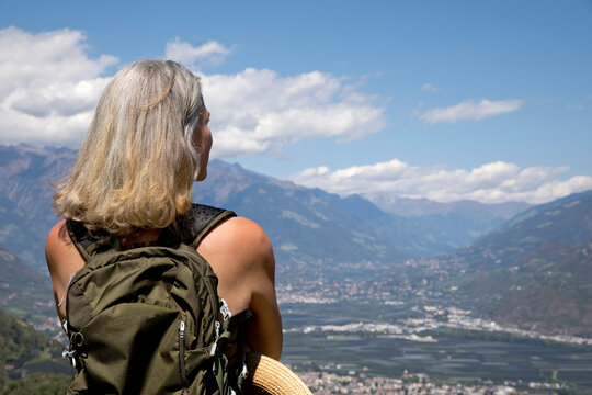 Senior woman with gray hair looking at landscape on sunny day