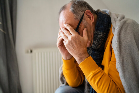 Depressed Senior Man Covering Face At Home