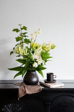 Studio shot of vase with white blooming flowers