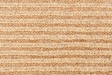 Fototapeta premium Knitwear texture background, pattern.Detail of a warm winter sweater.Beige