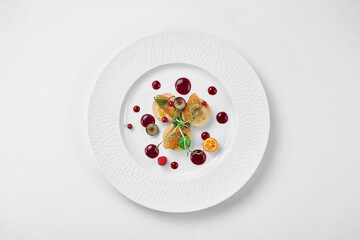 Foie gras with apple confit and berry sauce in a white plate on a white background. Close-up, selective focus. - obrazy, fototapety, plakaty