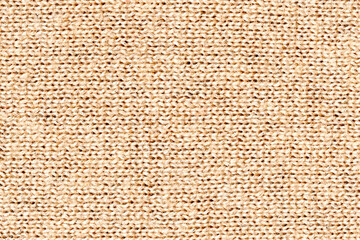 Knitwear texture background, pattern.Detail of a warm winter sweater.Beige