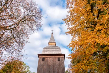 Poster The tower of the historic church made of wood. The church is covered with shingles. Autumn. Polanka Wielka, Poland © p  a  t  r  i  c  k