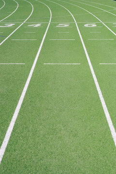 Numbers on empty running track at sports field