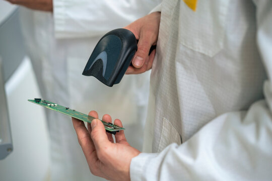 Engineer scanning circuit board with bar code scanner