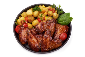 BBQ chicken wings with sesame seeds, spicy grilled meat with baked potatoes, close-up, isolated on white background.