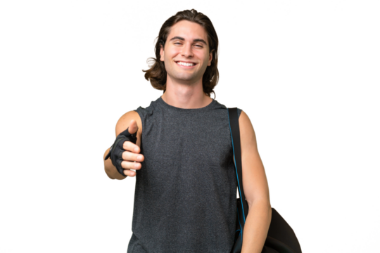 Young sport handsome man isolated on green chroma background shaking hands for closing a good deal