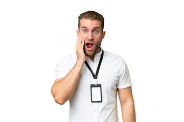 Young caucasian man with ID card isolated on green chroma background with surprise and shocked facial expression
