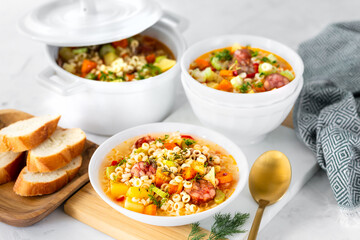 Smoked sausage minestrone. Italian soup with pasta and seasonal vegetables.