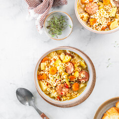 Smoked sausage minestrone tubetti pasta or orzo. Traditional Italian soup with pasta and seasonal...