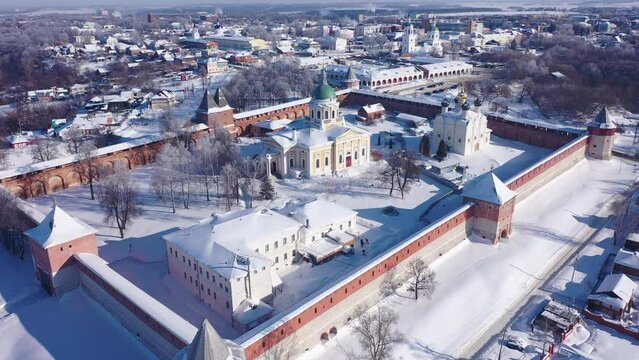 View from drone of snow covered architectural ensemble of Zaraysk Kremlin with Forerunner and St. Nicholas cathedrals on winter day, Russia