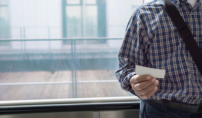 A senior man or a middle-aged man checking A train ticket. 電車の切符を確認しているシニア男性または中高年男性