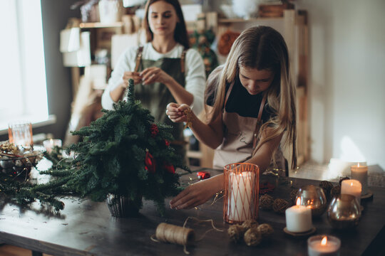 A woman makes a Christmas tree with her own hands. High quality photo