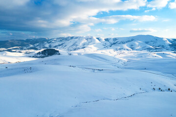 Fototapeta na wymiar Aerial shot of beautiful snow capped mountains and hills winter landscape of Zlatibor, famous travel destination in Serbia