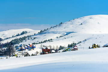 Snow at Zlatibor mountain landscape in winter, houses and trees on hills in this popular serbian...