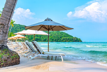 Sunbeds on tropical beach in Phu Quoc island, Vietnam. Beach's smile