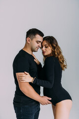 Happy pregnant couple looking to the future on white background